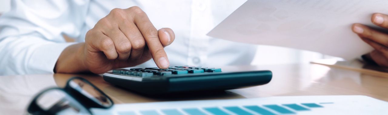 Finances Saving Economy concept. Female accountant or banker use calculator.